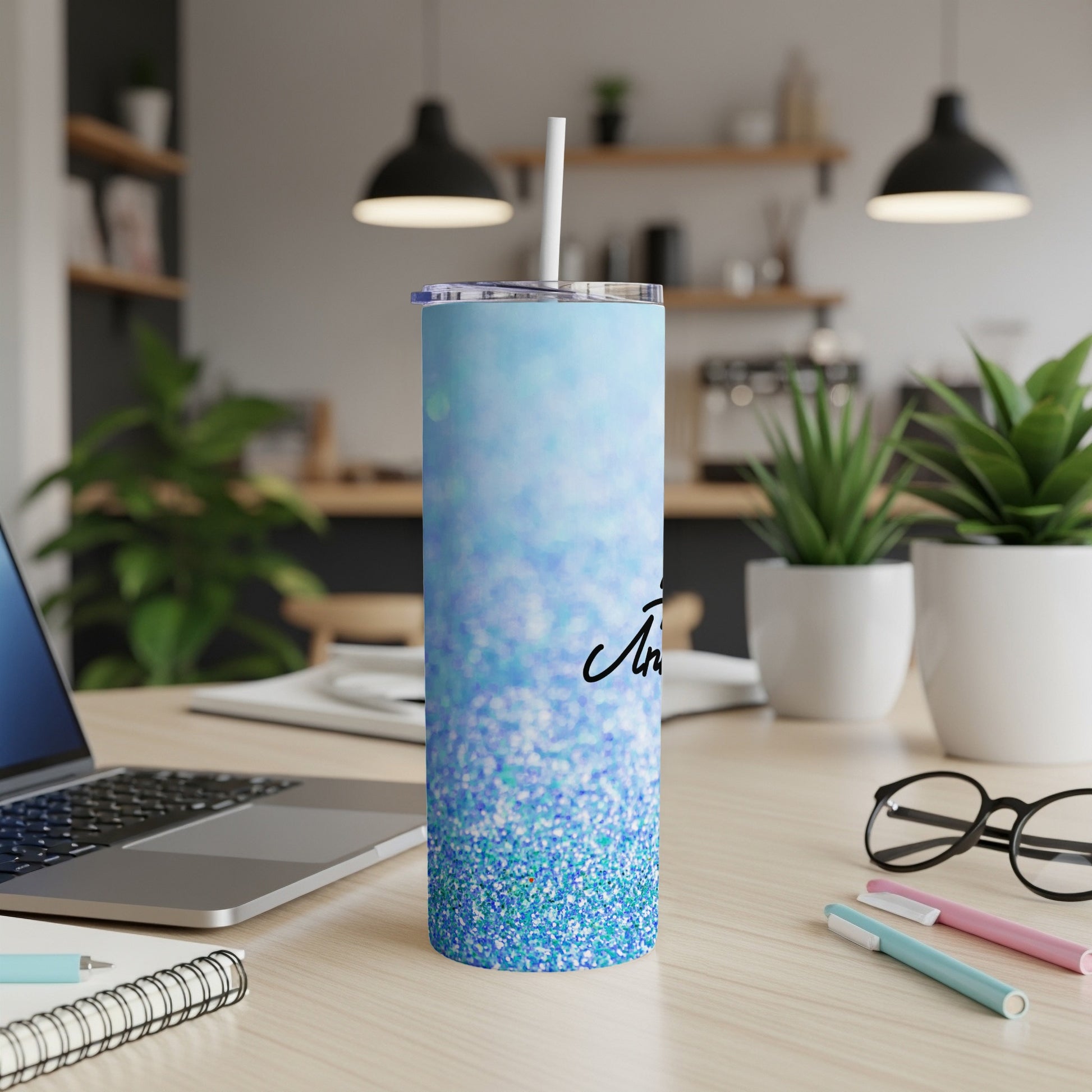 Blue glitter tumbler with "In My Feelings" text on desk with laptop.