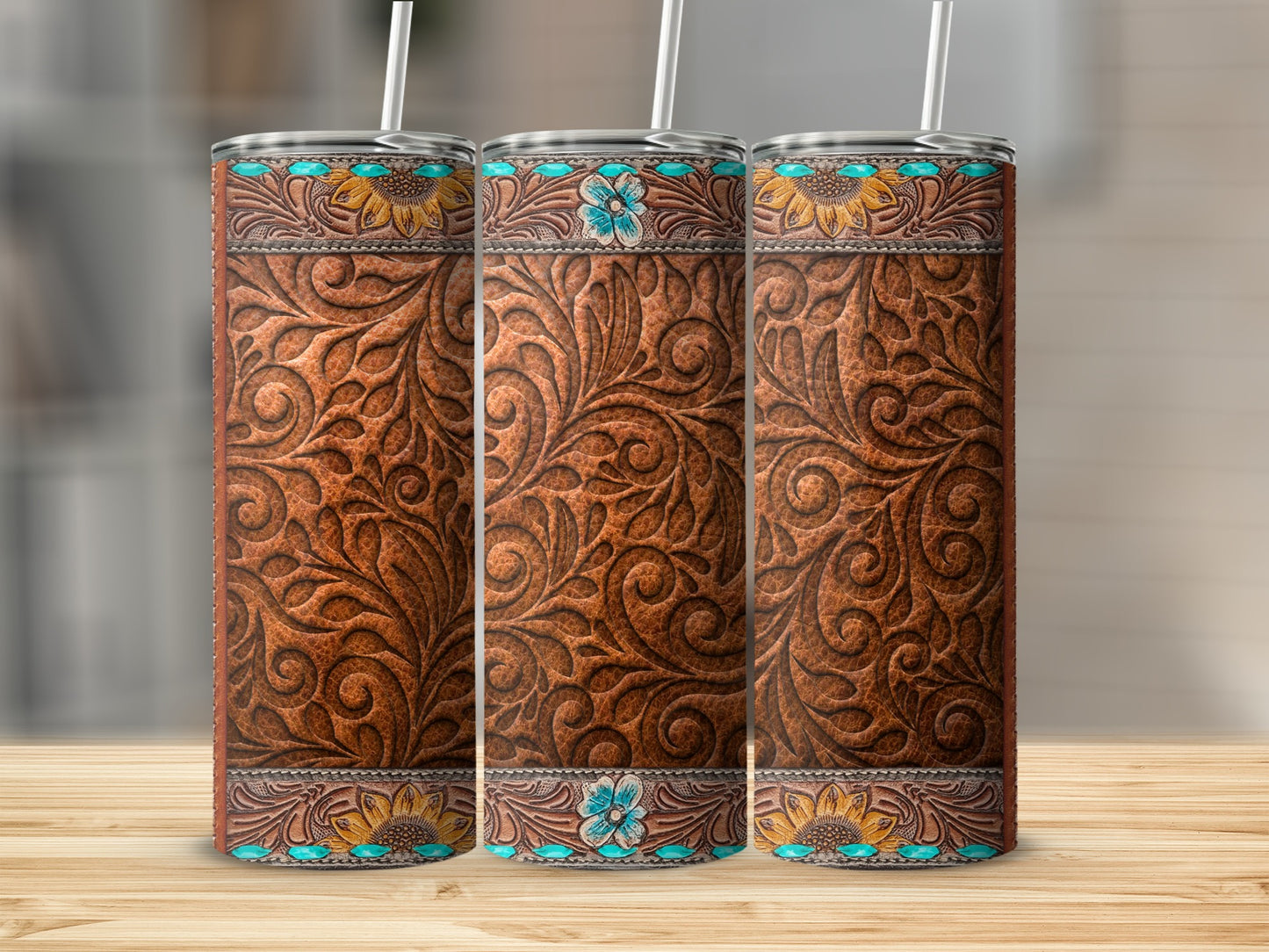 Three western-style embossed leather tumblers with sunflowers and turquoise details.