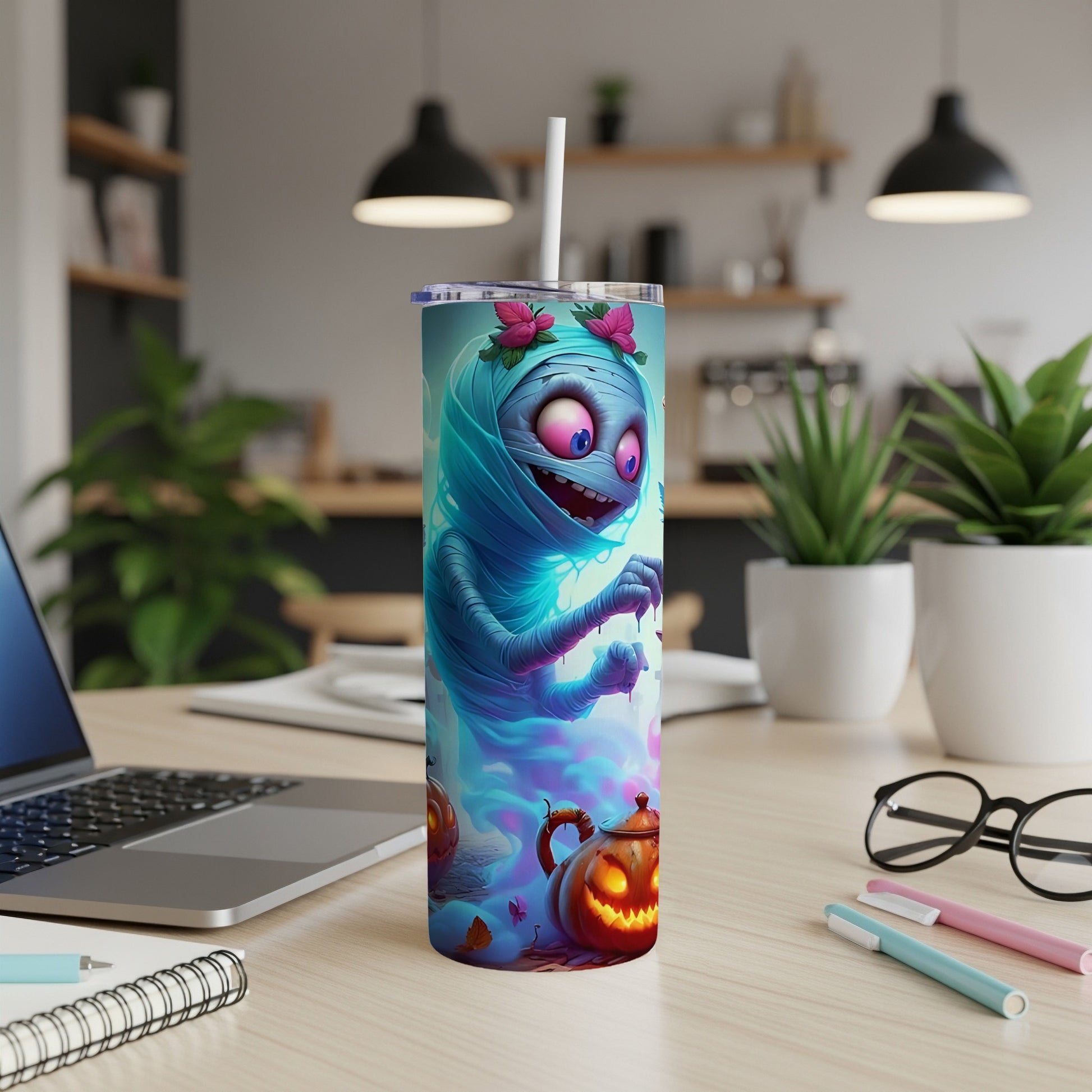 Tumbler with cartoon mummy, pink flowers, and glowing jack-o'-lanterns.