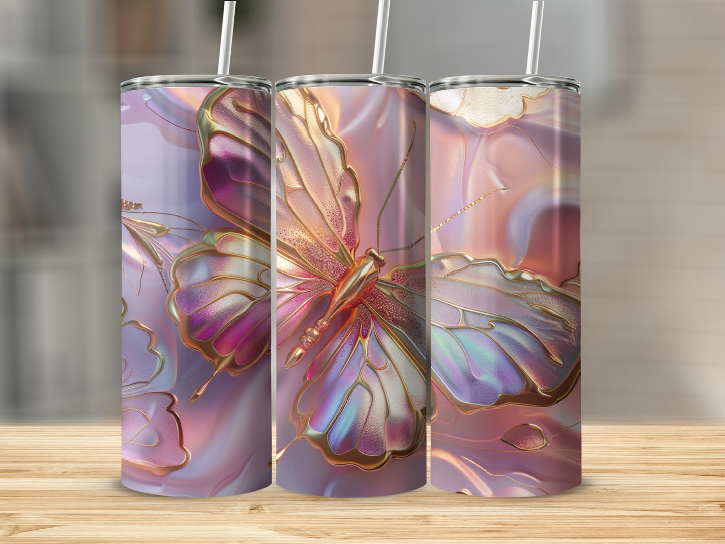 Three iridescent tumblers featuring golden butterflies on a light wood surface.