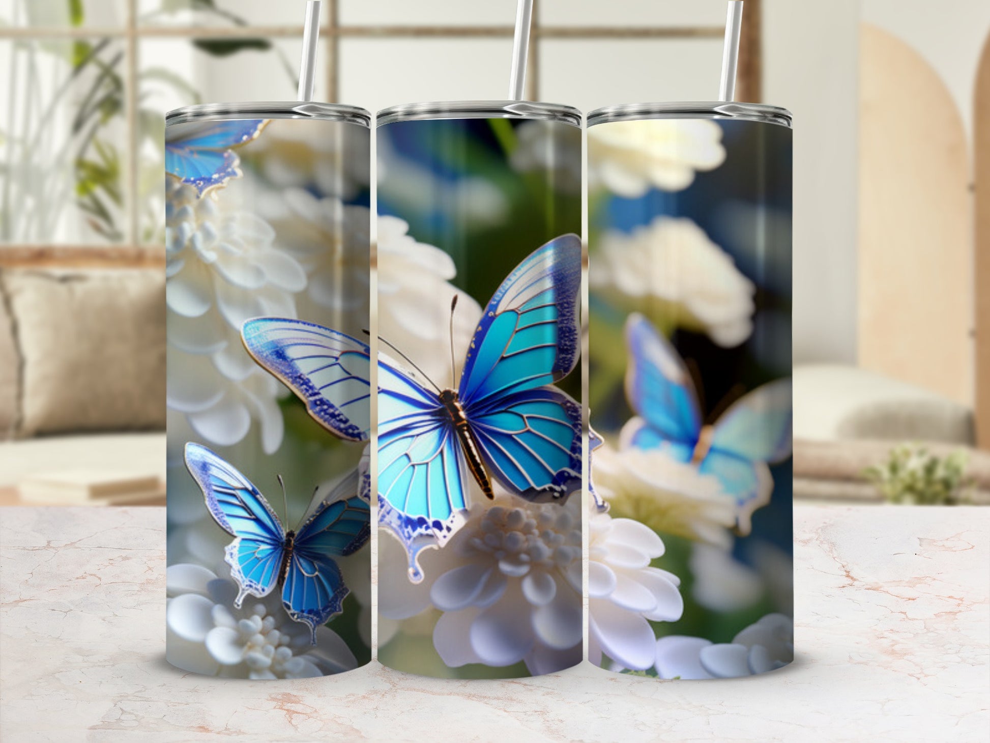 Three tumblers with blue butterflies and white flowers design.