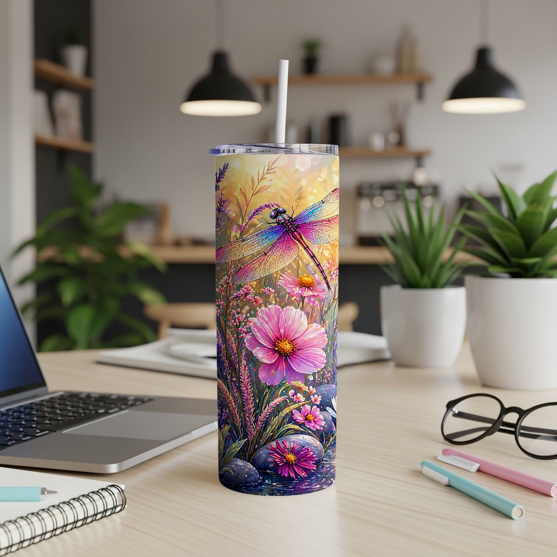 Dragonfly and floral pattern on a white tumbler with a straw.