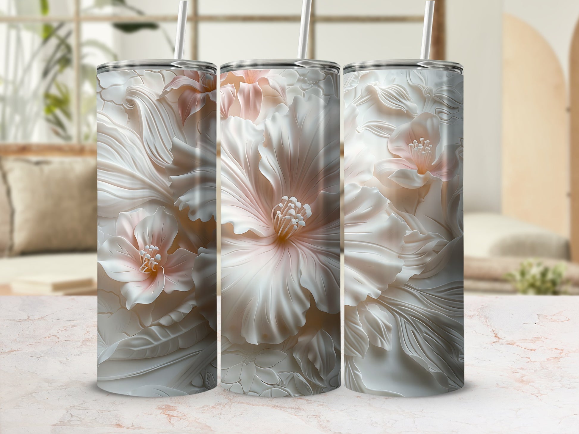 Three white floral tumblers with pink centers, presented on a marble surface.