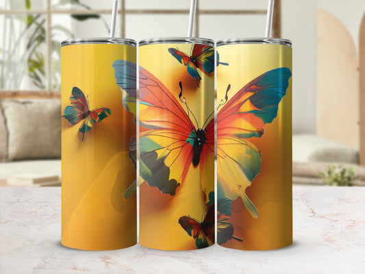Three tumblers with vibrant butterfly designs on a yellow gradient background.