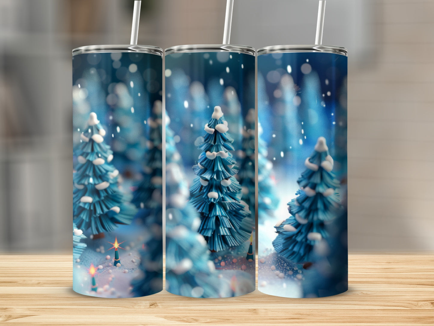 Three tumblers with snowy evergreen trees and bokeh lights.