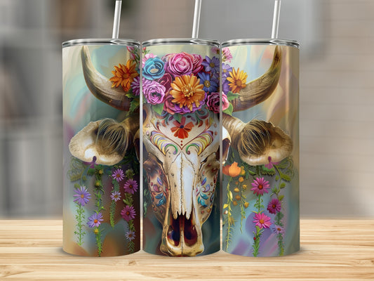 Sugar skull cow with floral headdress and colorful background on a tumbler.