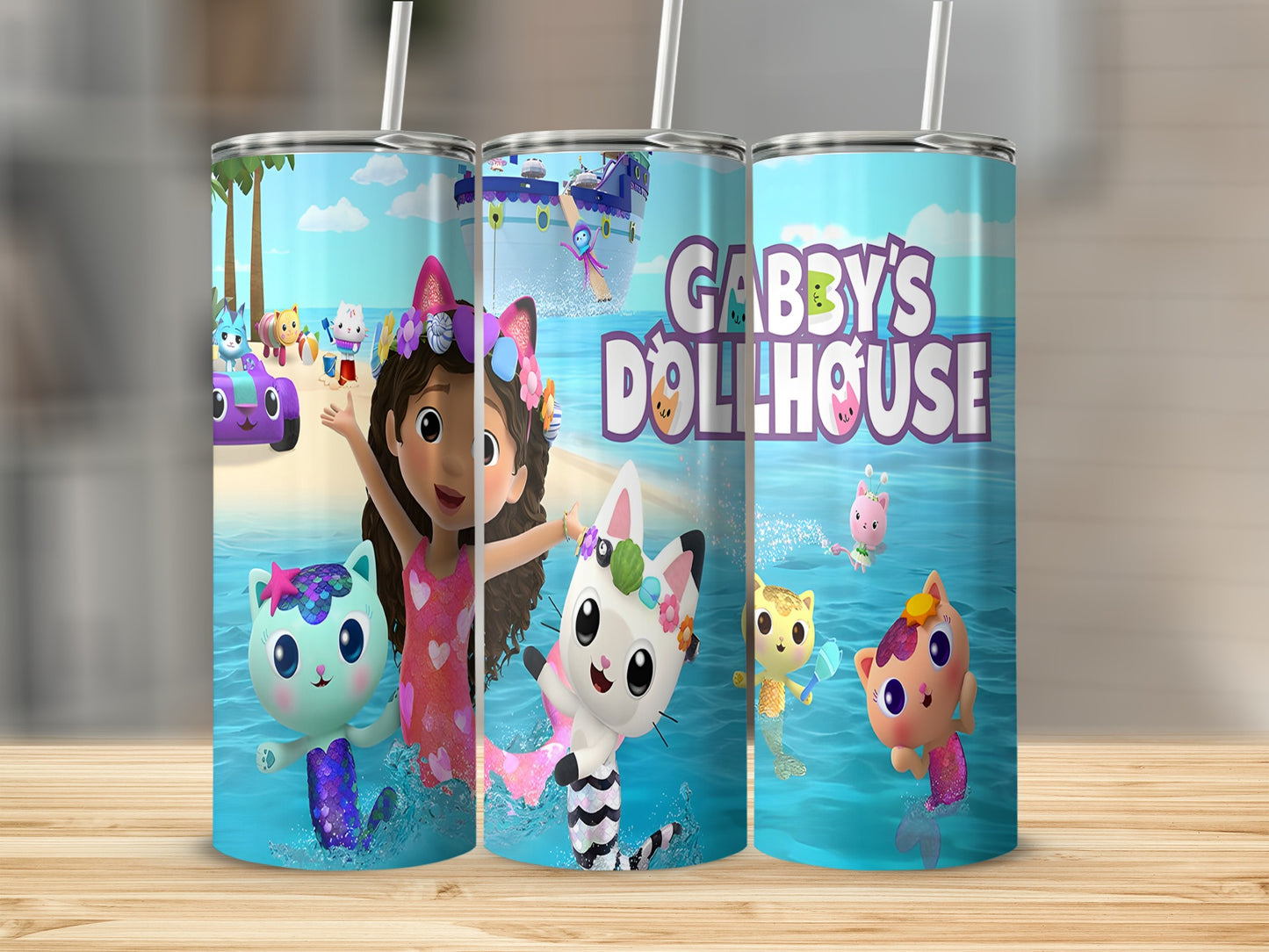Gabby's Dollhouse characters and logo on a blue water-themed tumbler.