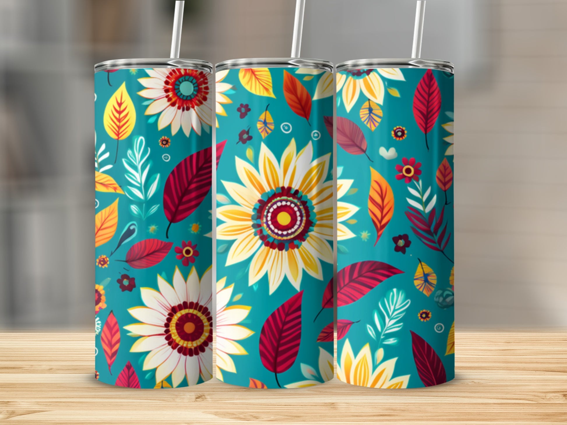 Three teal tumblers with a floral and leaf pattern.