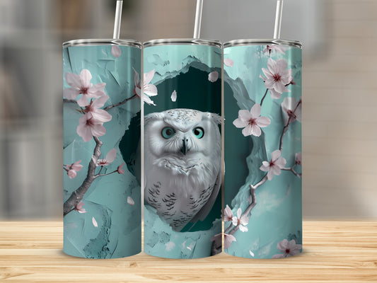 White owl with blue eyes and pink blossoms on teal background tumbler.