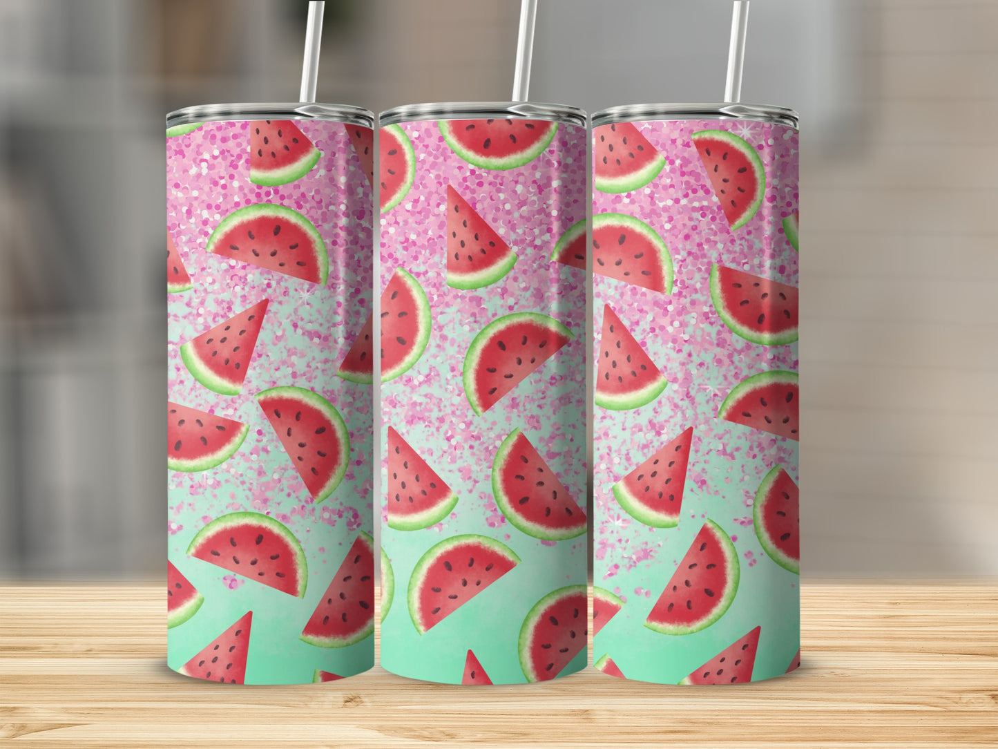 Three tall tumblers with watermelon slices and glitter on a wooden surface.
