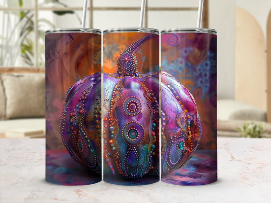 Purple, jeweled pumpkin art on a tumbler with a straw.