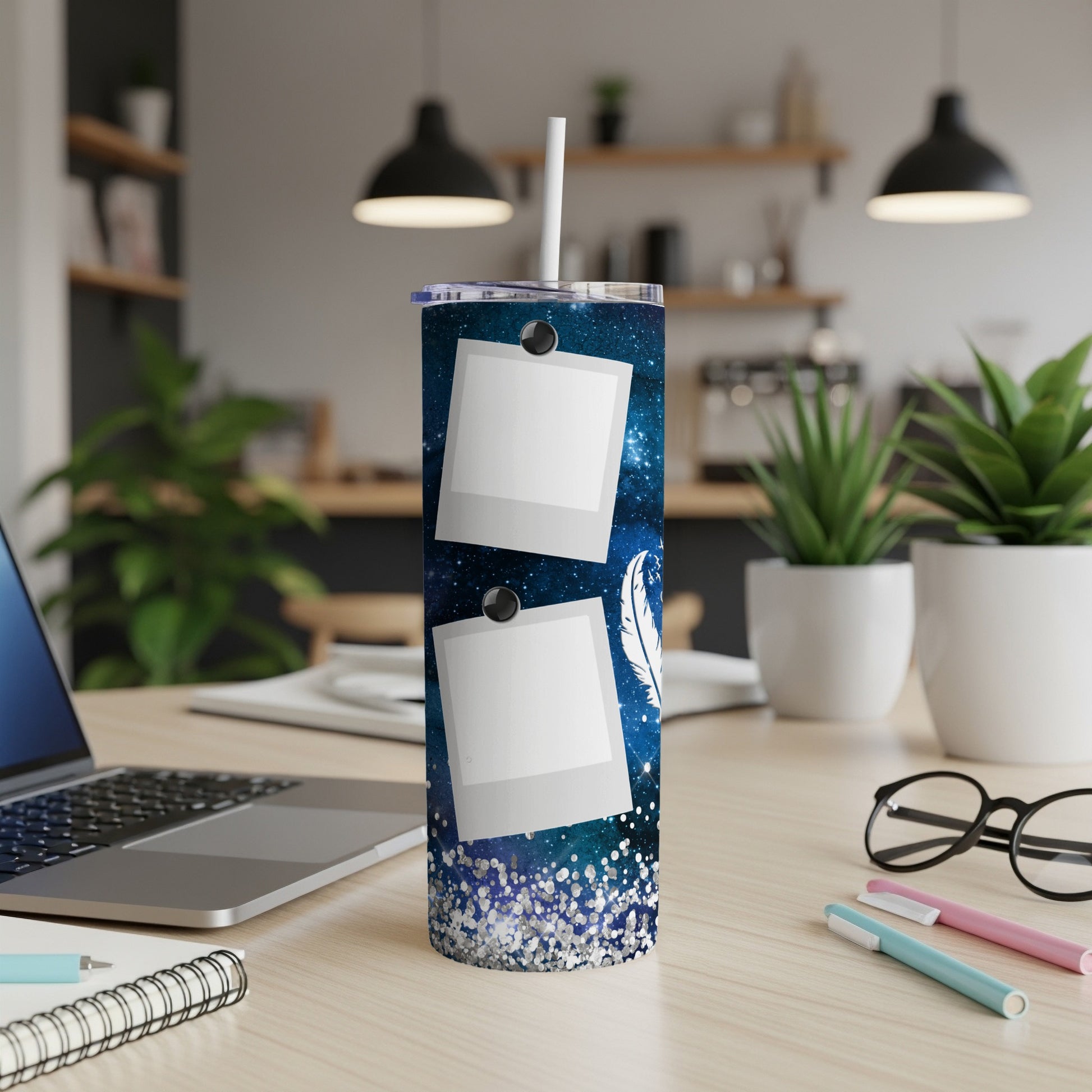 Blue starry tumbler with two empty photo frames and a feather.