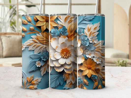 Three tumblers with floral designs in blue, gold, and white.