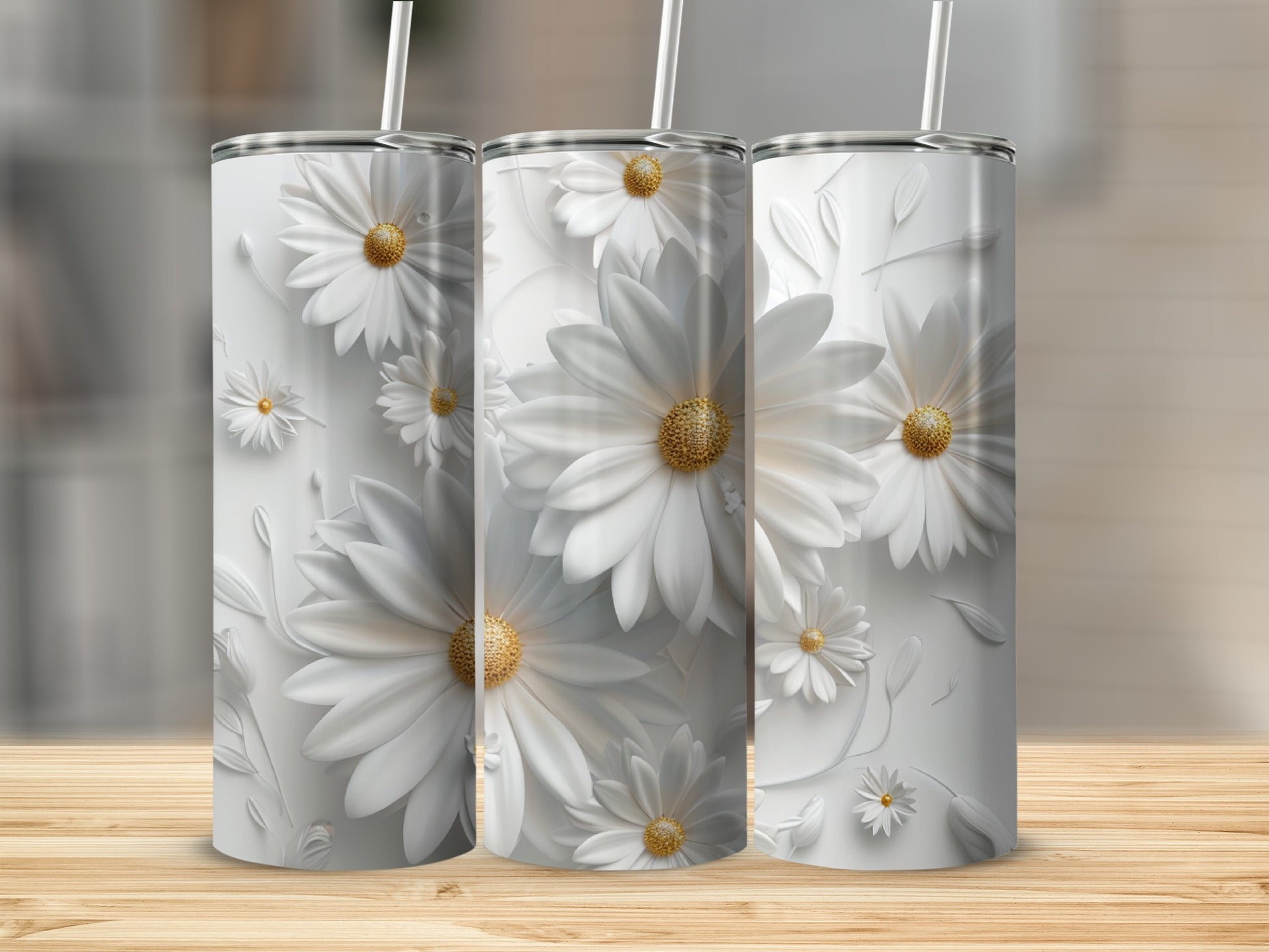 Three white tumblers with embossed daisies on a wooden surface.