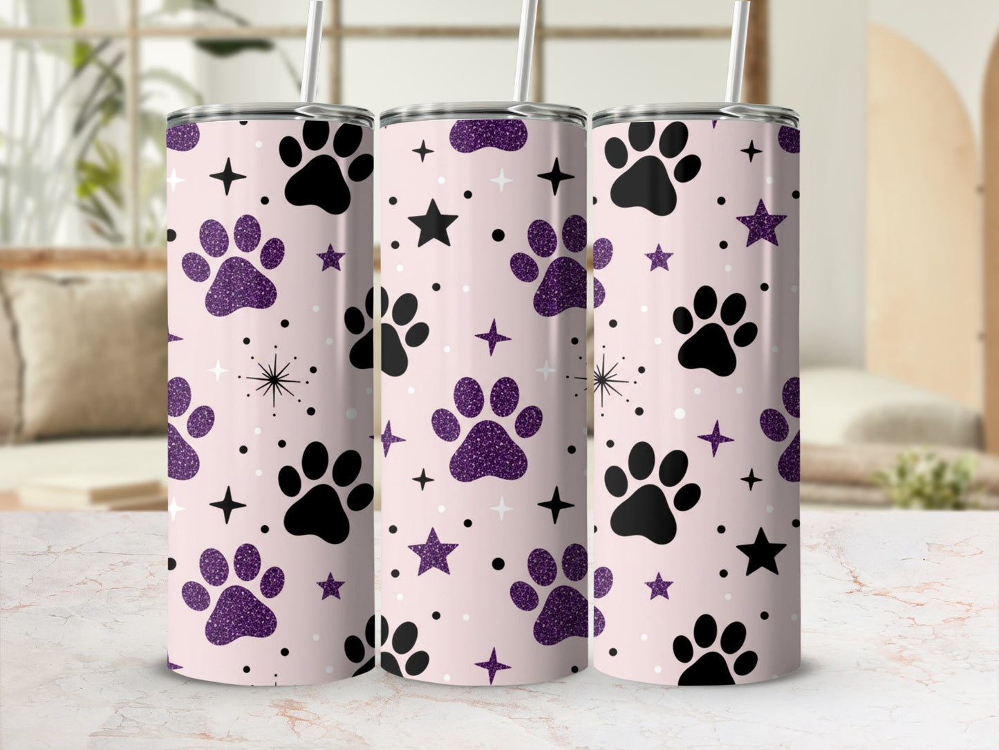 Pink tumbler with black paw prints and purple glitter stars.