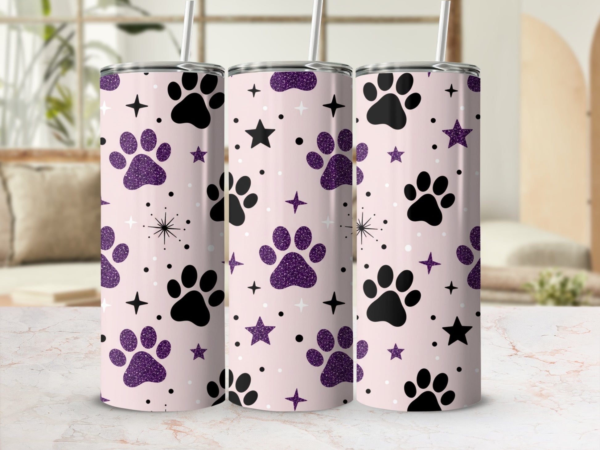 Pink tumbler with black paw prints and purple glitter stars.