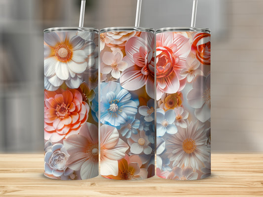 Three tumblers with floral designs featuring orange, blue, and white flowers.
