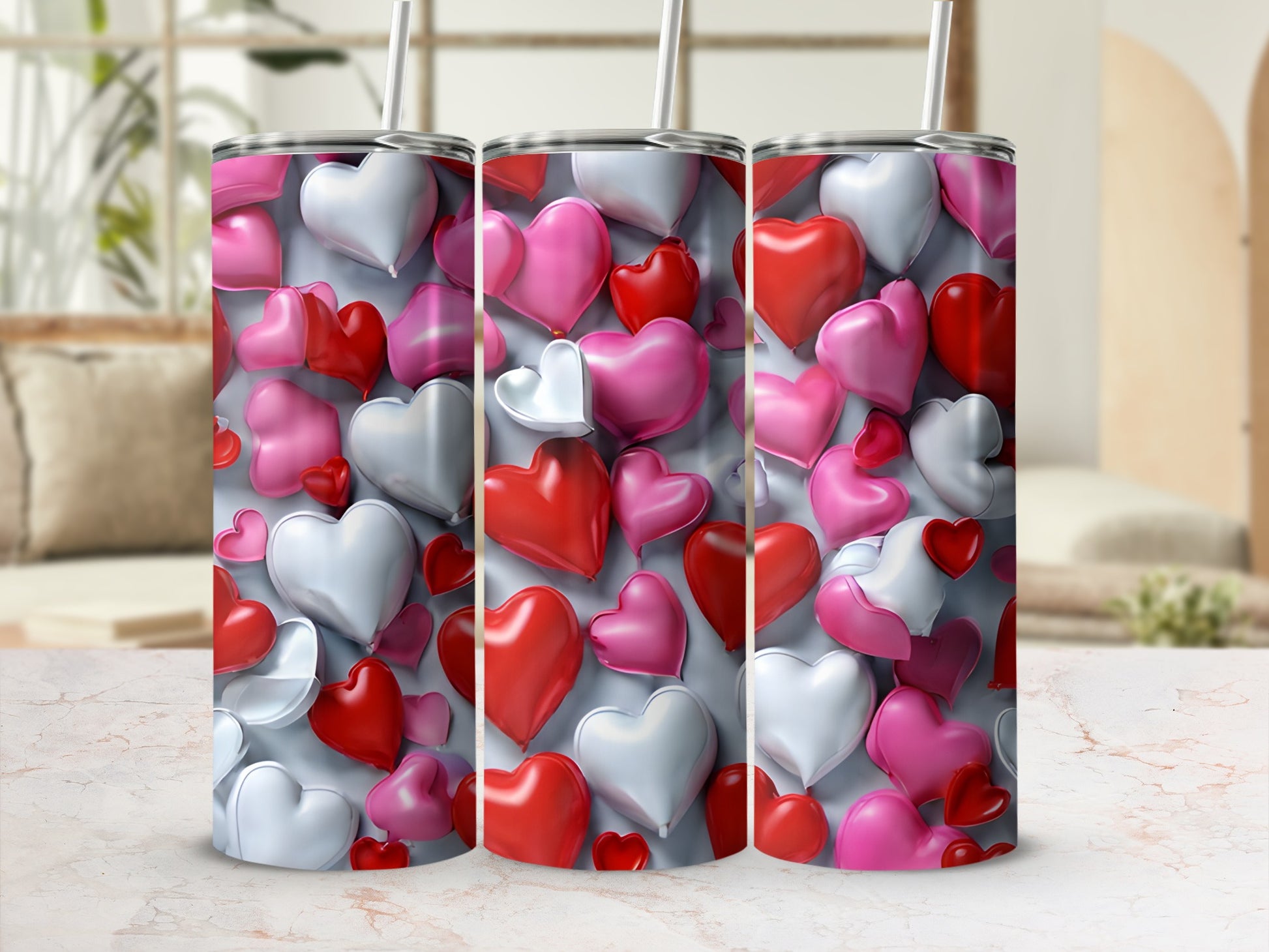 Three tumblers adorned with a pattern of red, pink, and white hearts.