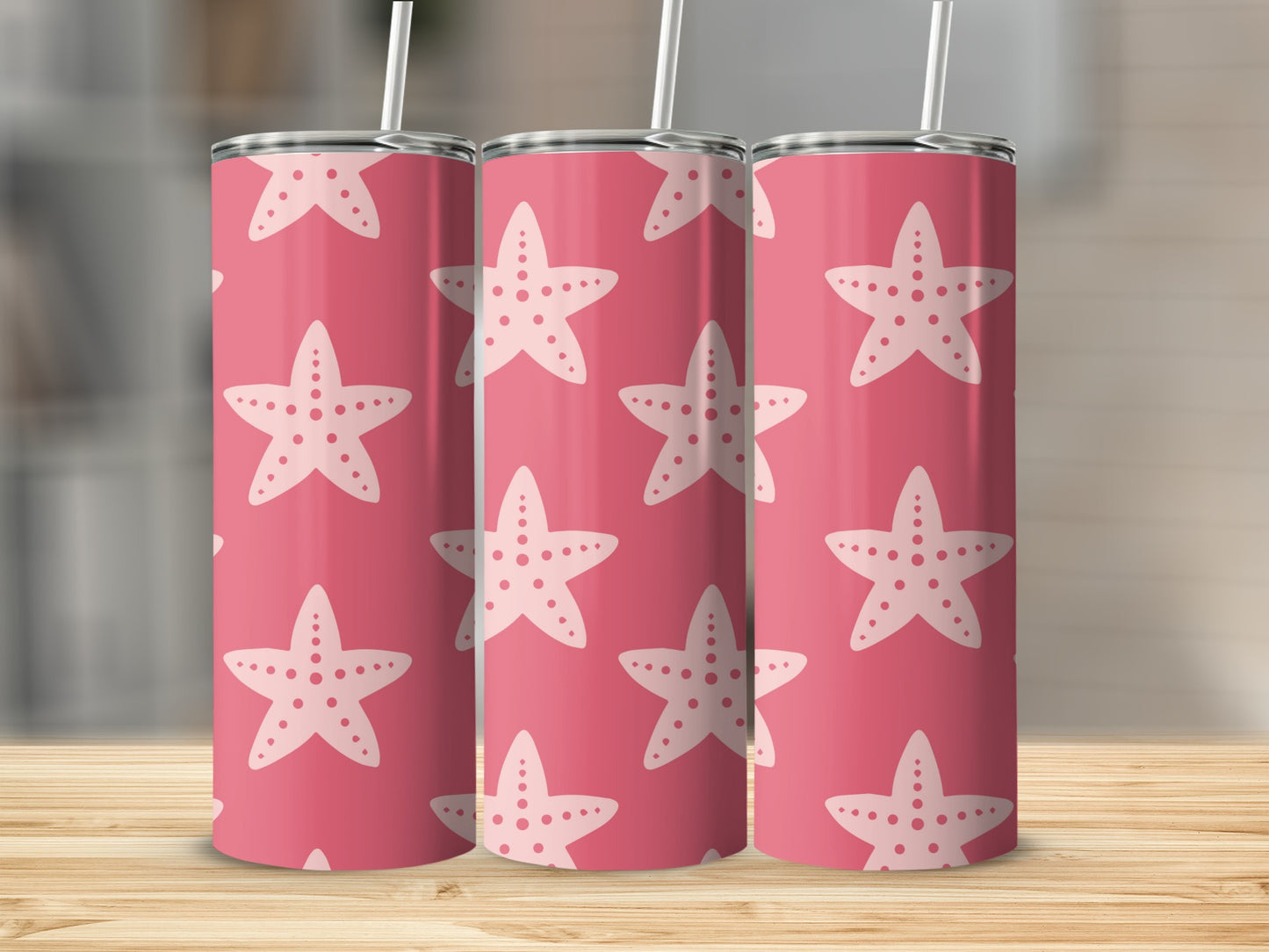 Pink tumbler with white starfish pattern and straw.