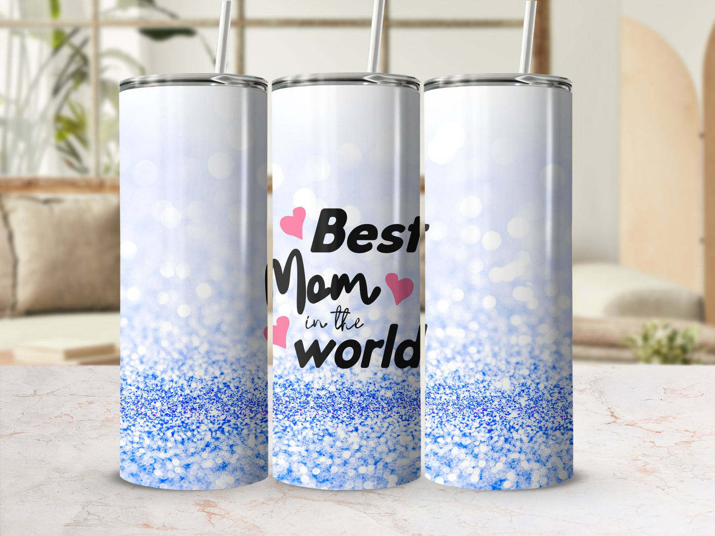 Three tumblers with "Best Mom in the World" text and blue glitter design.