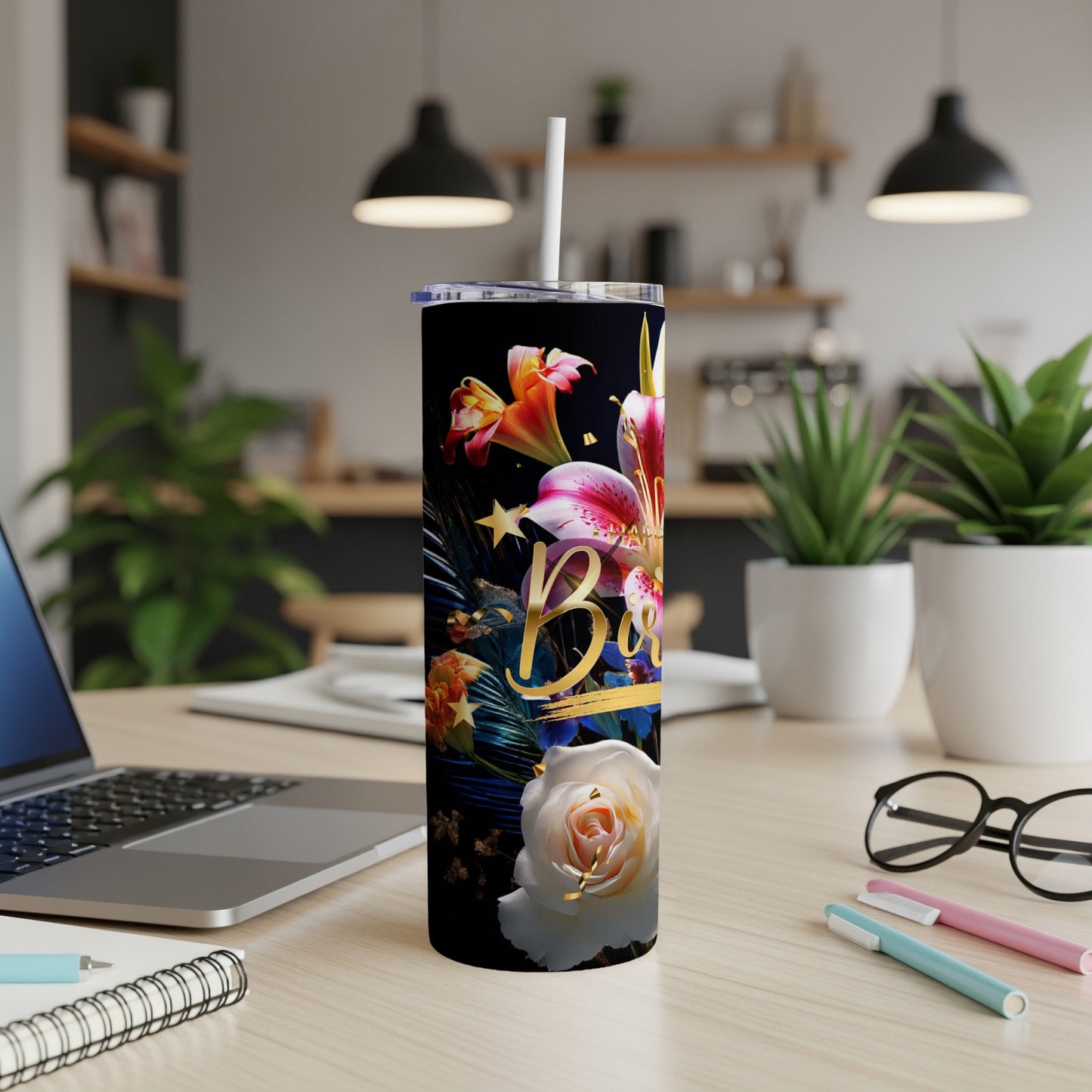 Black tumbler with colorful flowers and gold lettering reading "Best".