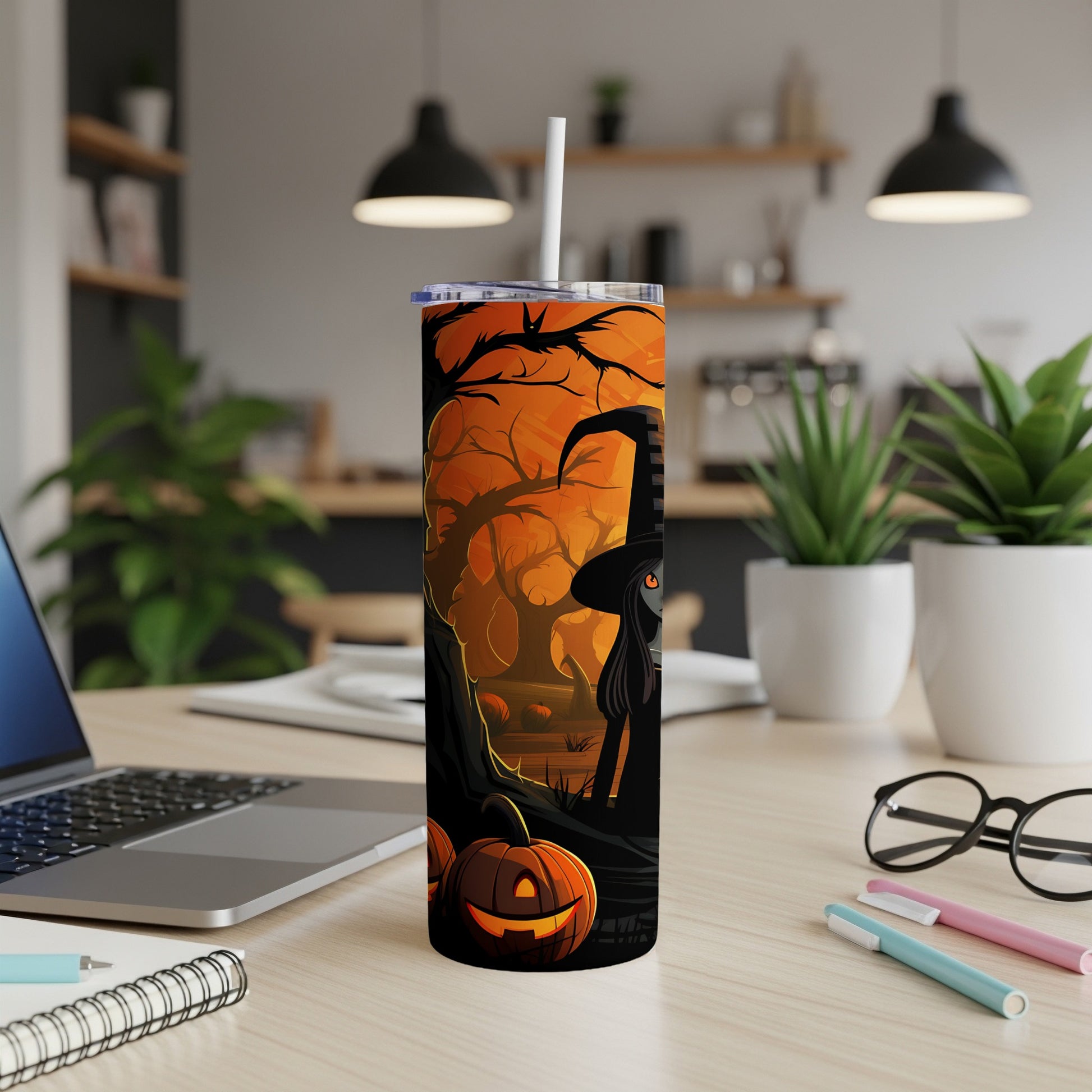 Halloween tumbler with witch, pumpkins, and spooky trees on orange background.