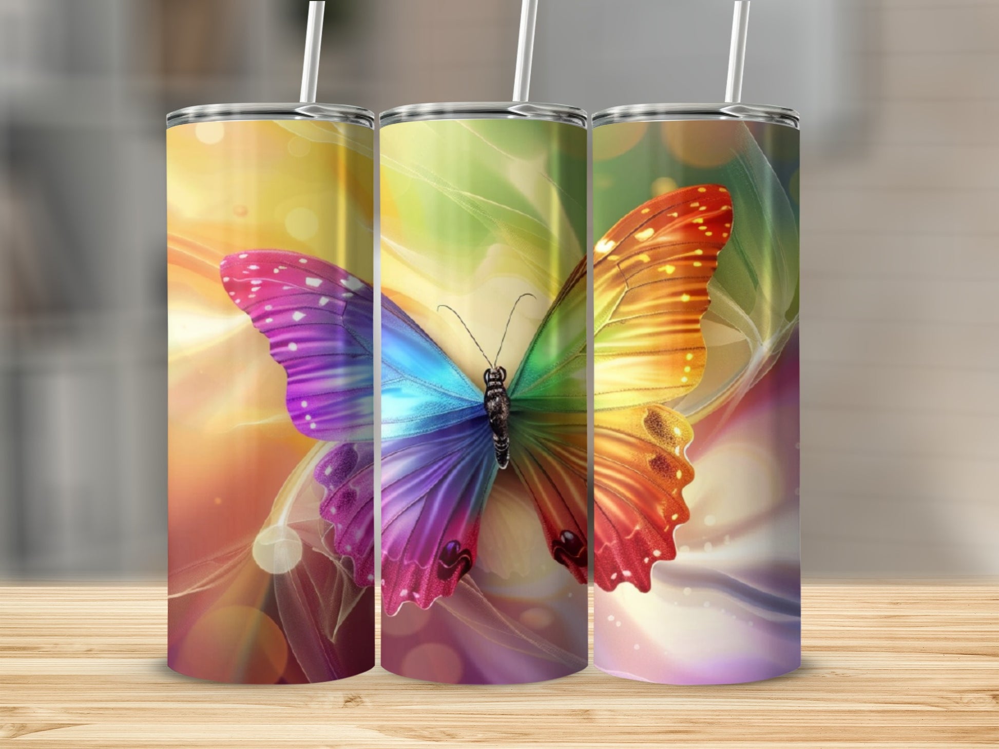 Three colorful butterfly tumblers with abstract backgrounds.