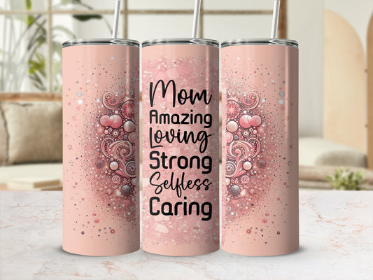 Pink tumbler with "Mom Amazing Loving Strong Selfless Caring" text and glitter details.
