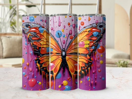 Tumbler with vibrant butterfly and colorful paint splatter design.