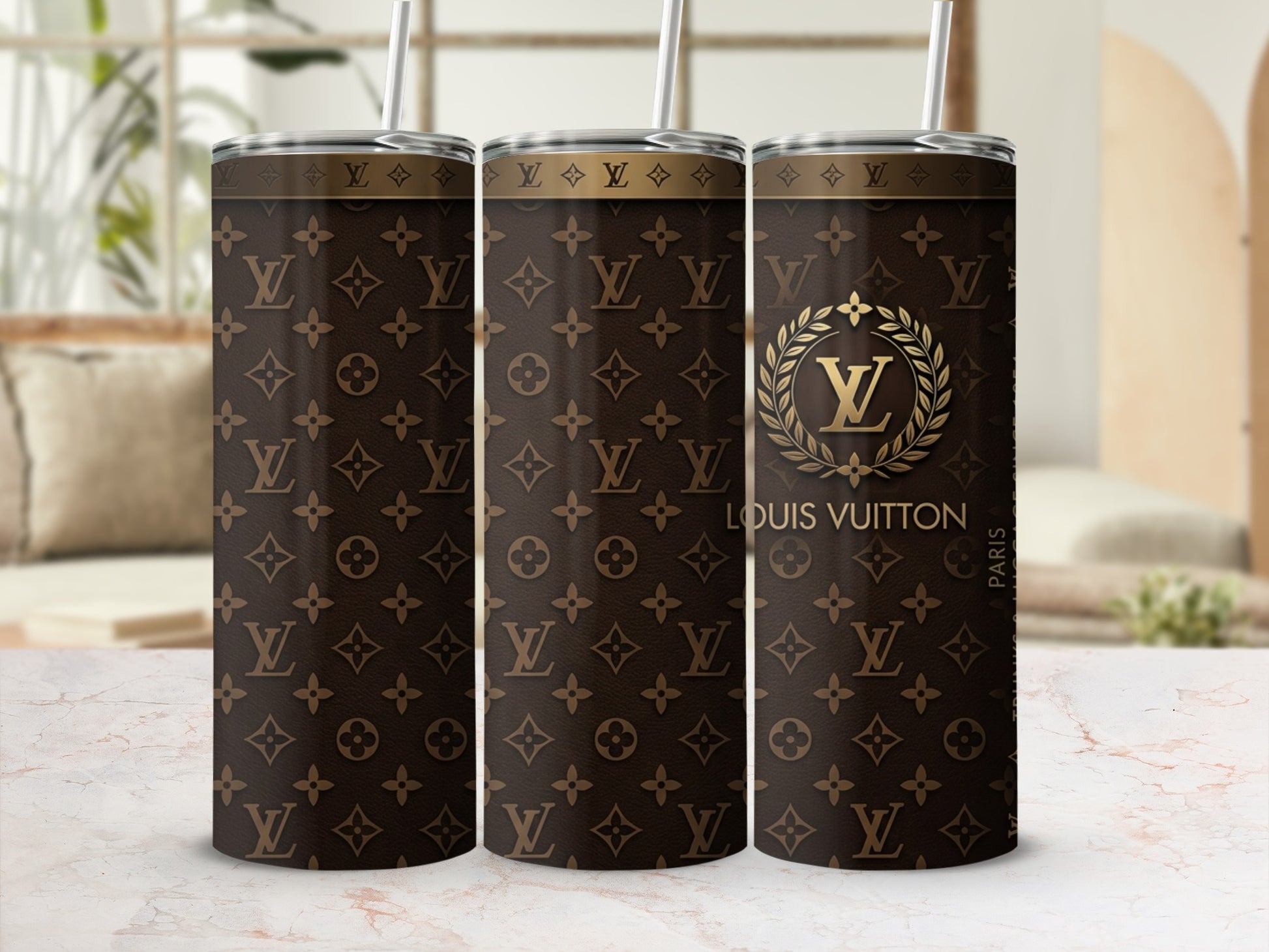 Three Louis Vuitton monogram tumblers with gold logo and Paris text.