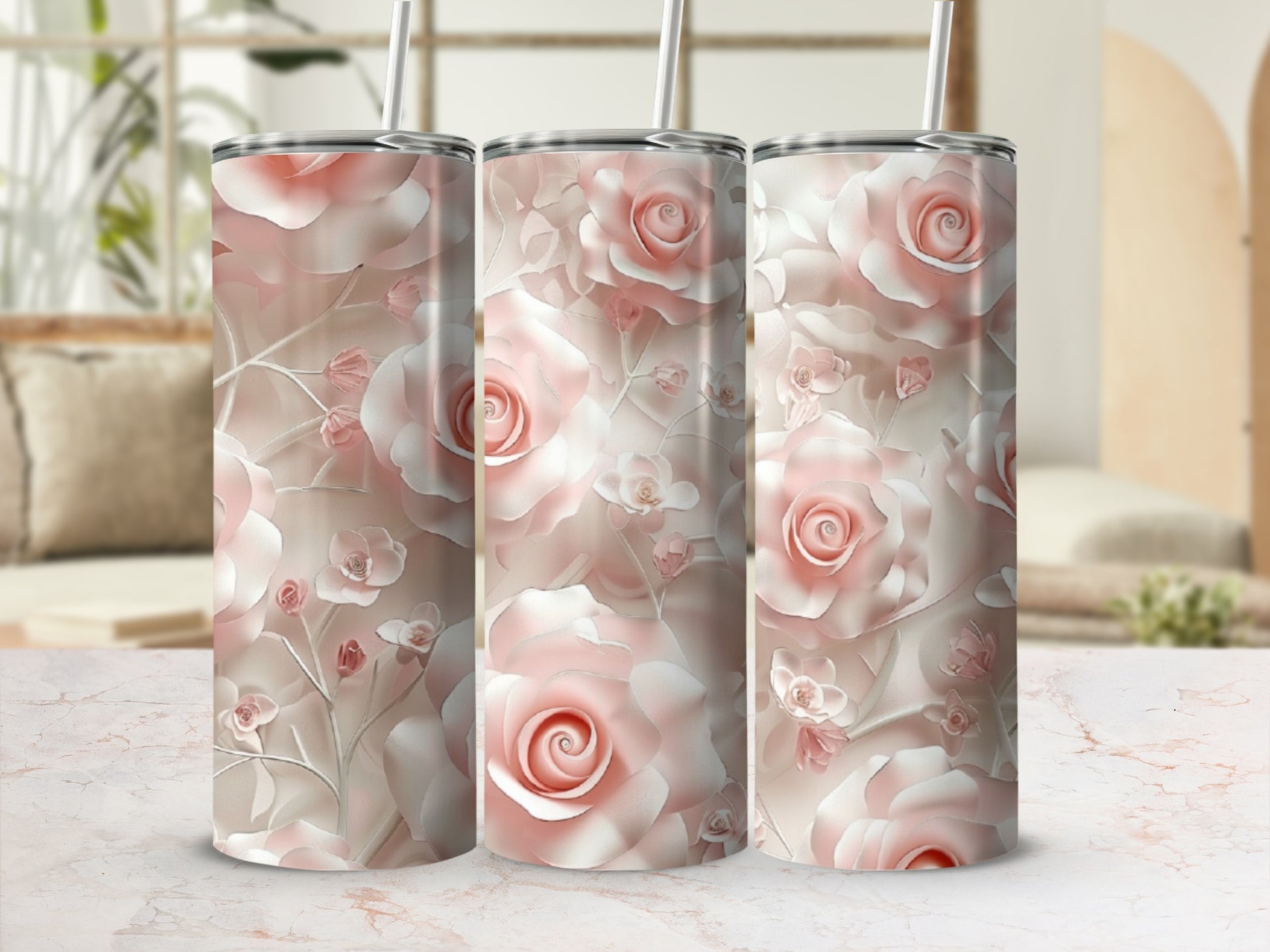 Three pastel pink rose floral tumblers with straws.