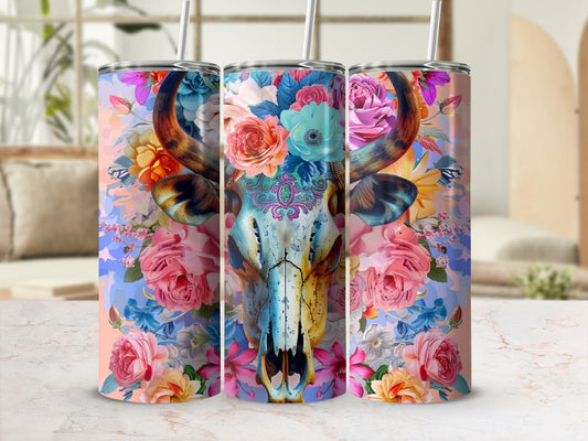 Skull with floral accents and colorful patterns on a cylindrical tumbler.