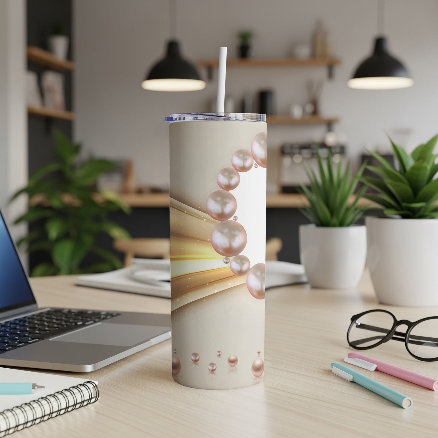 Cream tumbler with floating pearl and gold ribbon design.