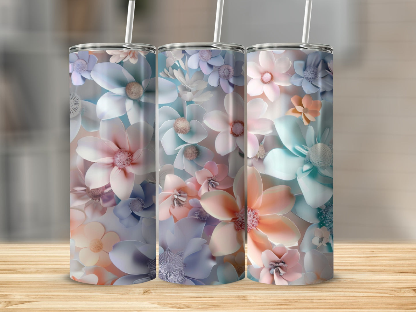 Three tumblers with pastel floral designs arranged side-by-side.
