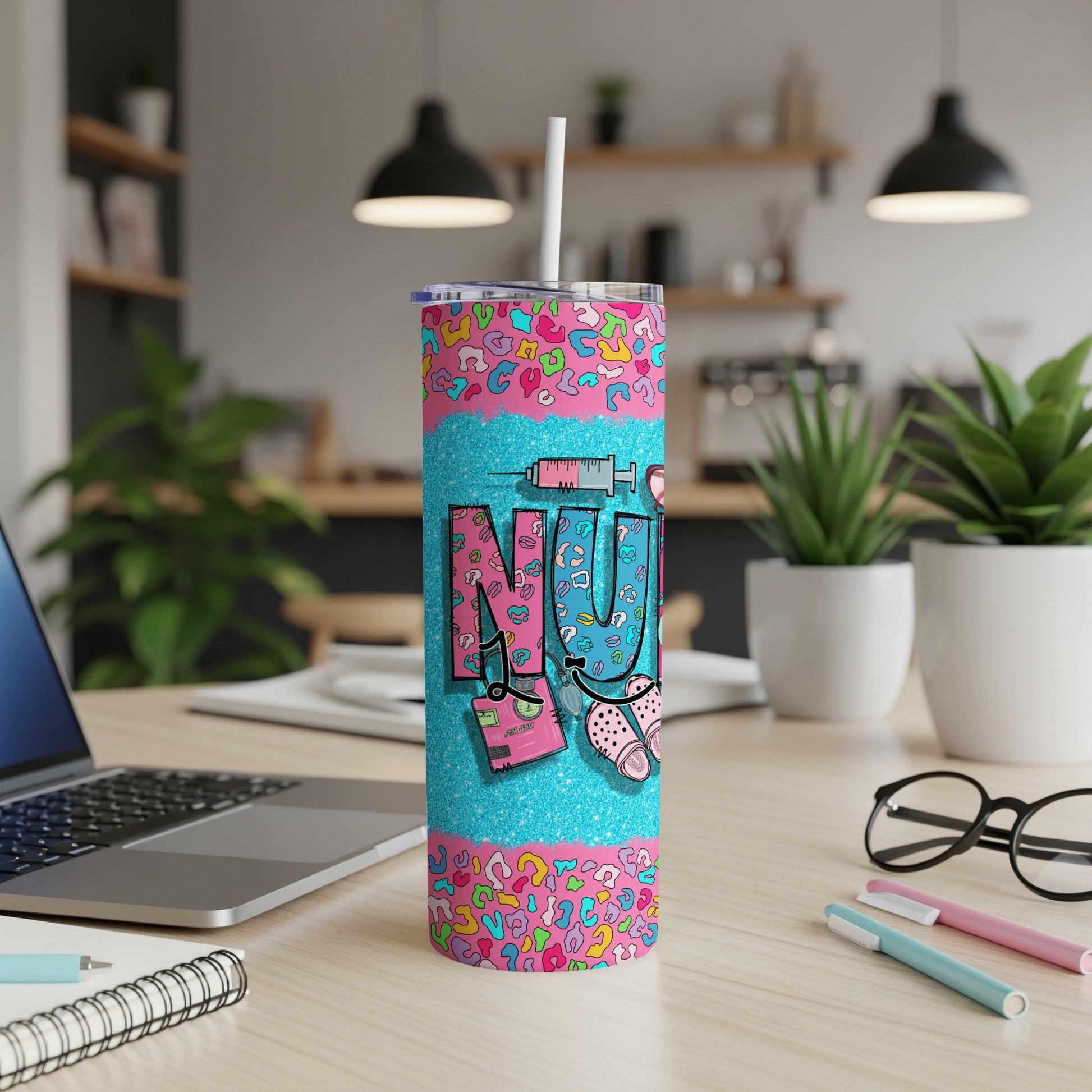 Tumbler with "NURSE" in pink letters on a sparkly blue background and leopard print.