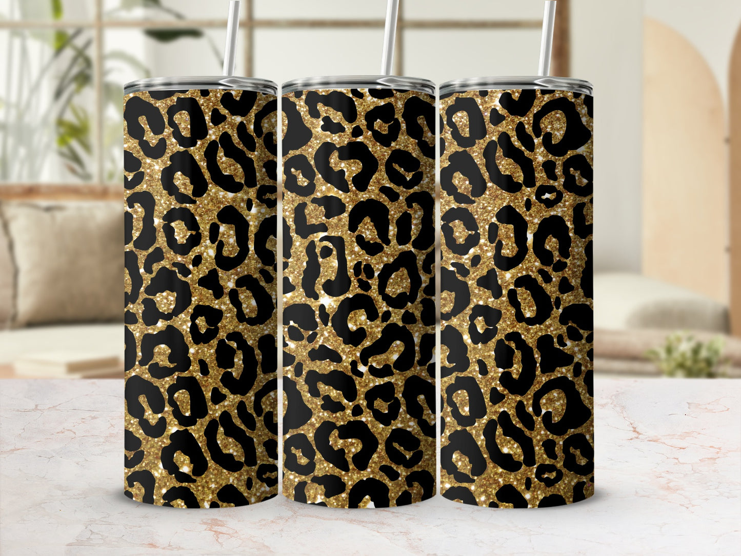 Three glittery gold tumblers with black leopard print pattern.