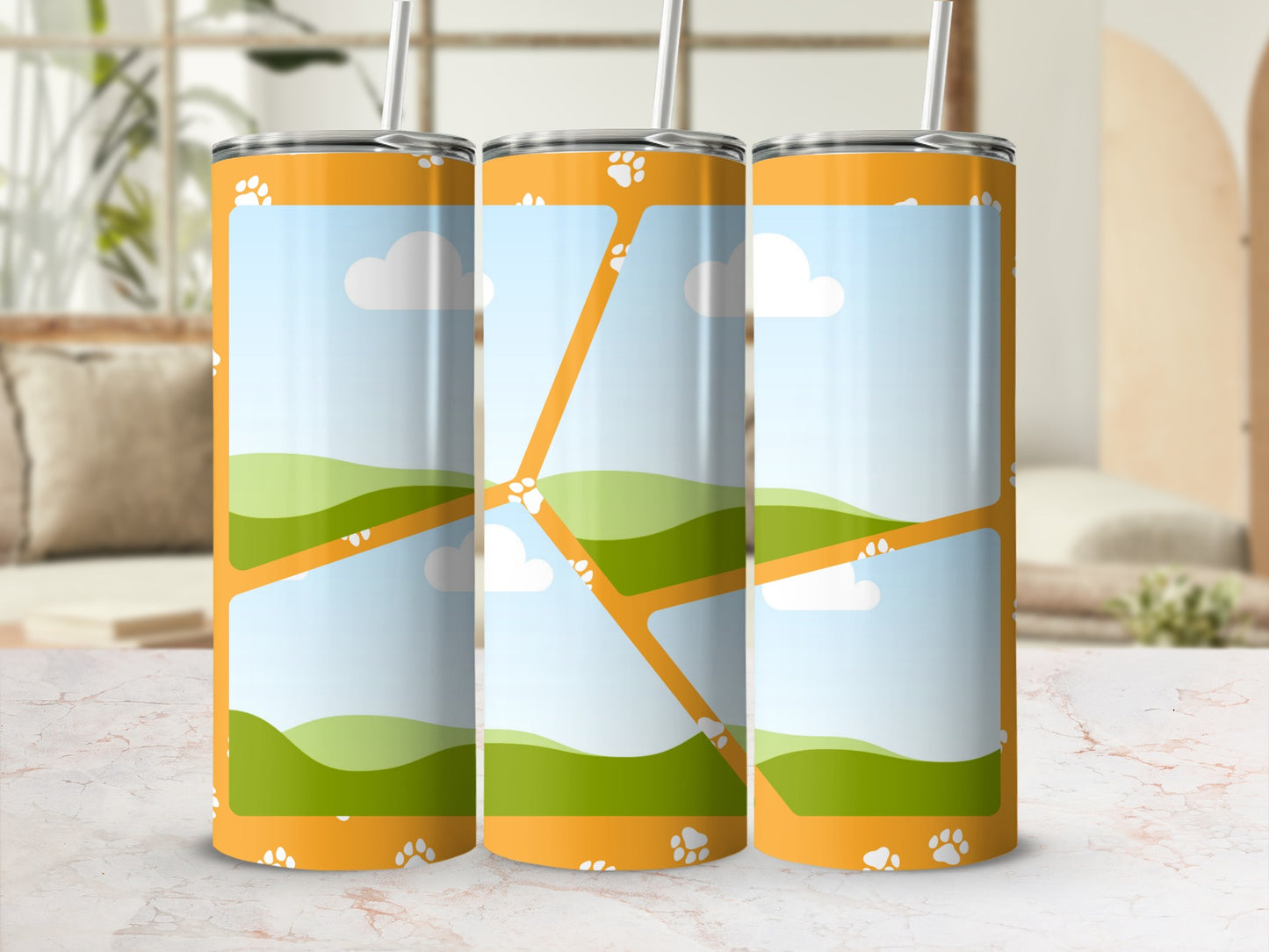 Three tumblers with an orange background, paw prints, and a landscape scene.