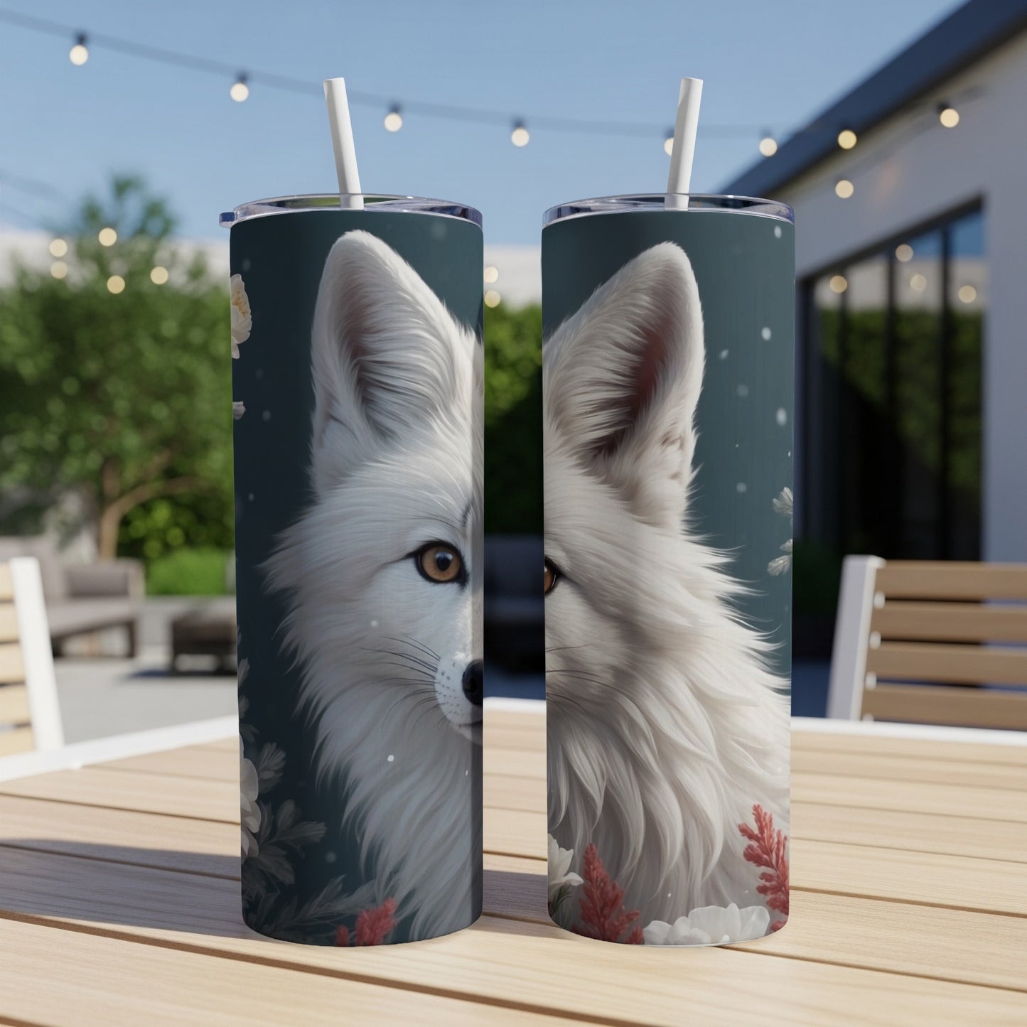White fox illustration on a dark blue, skinny tumbler with floral accents.