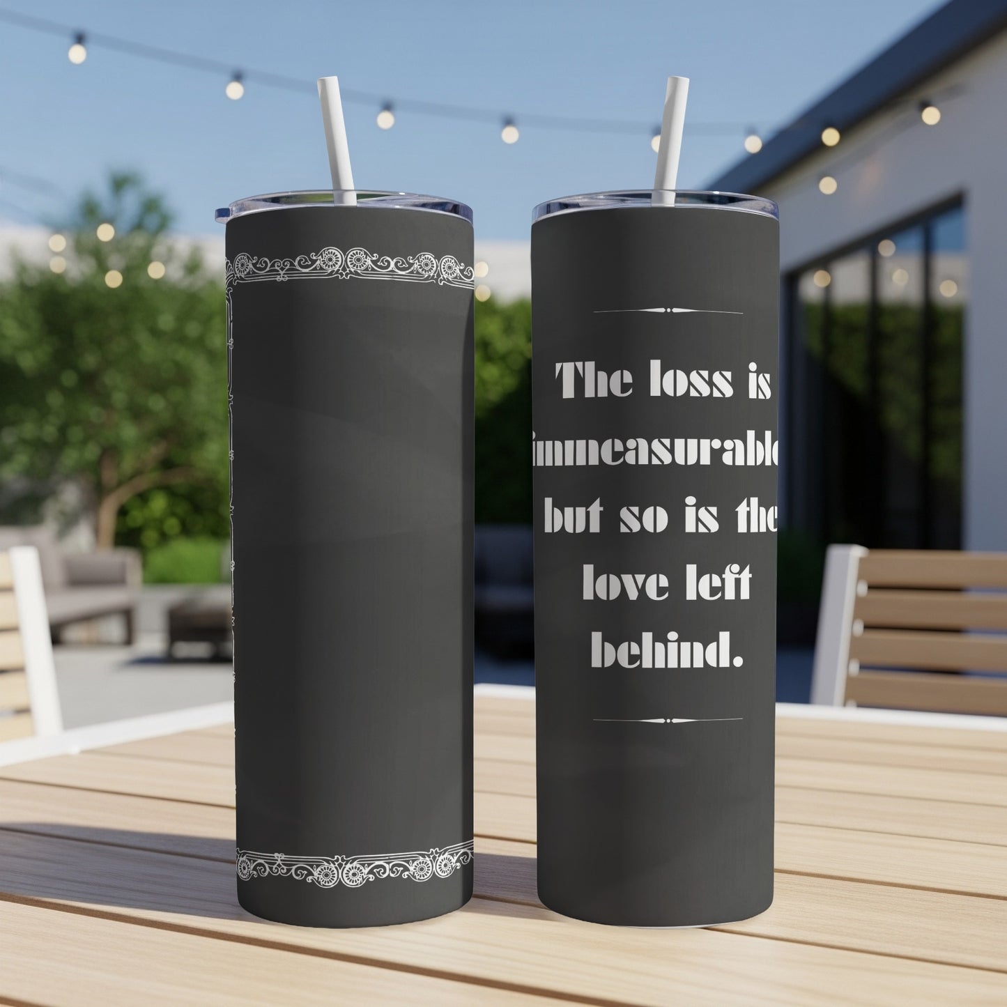 Dark grey tumbler with white decorative trim and text: "The loss is immeasurable but so is the love left behind."