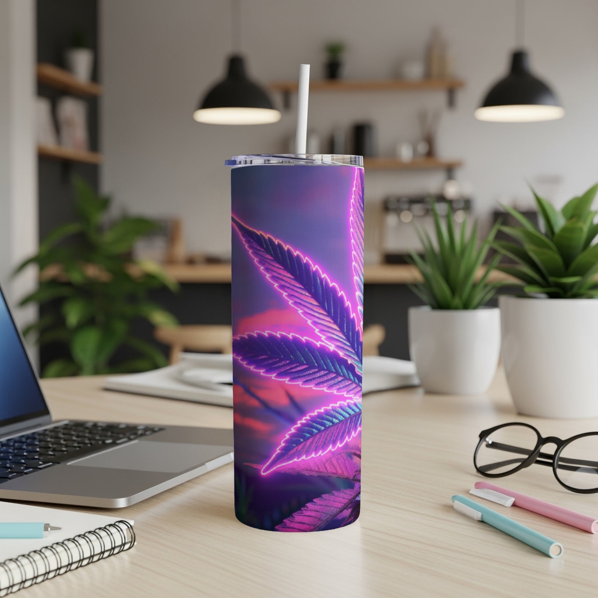 Neon purple cannabis leaf tumbler on a desk with a laptop and office supplies.