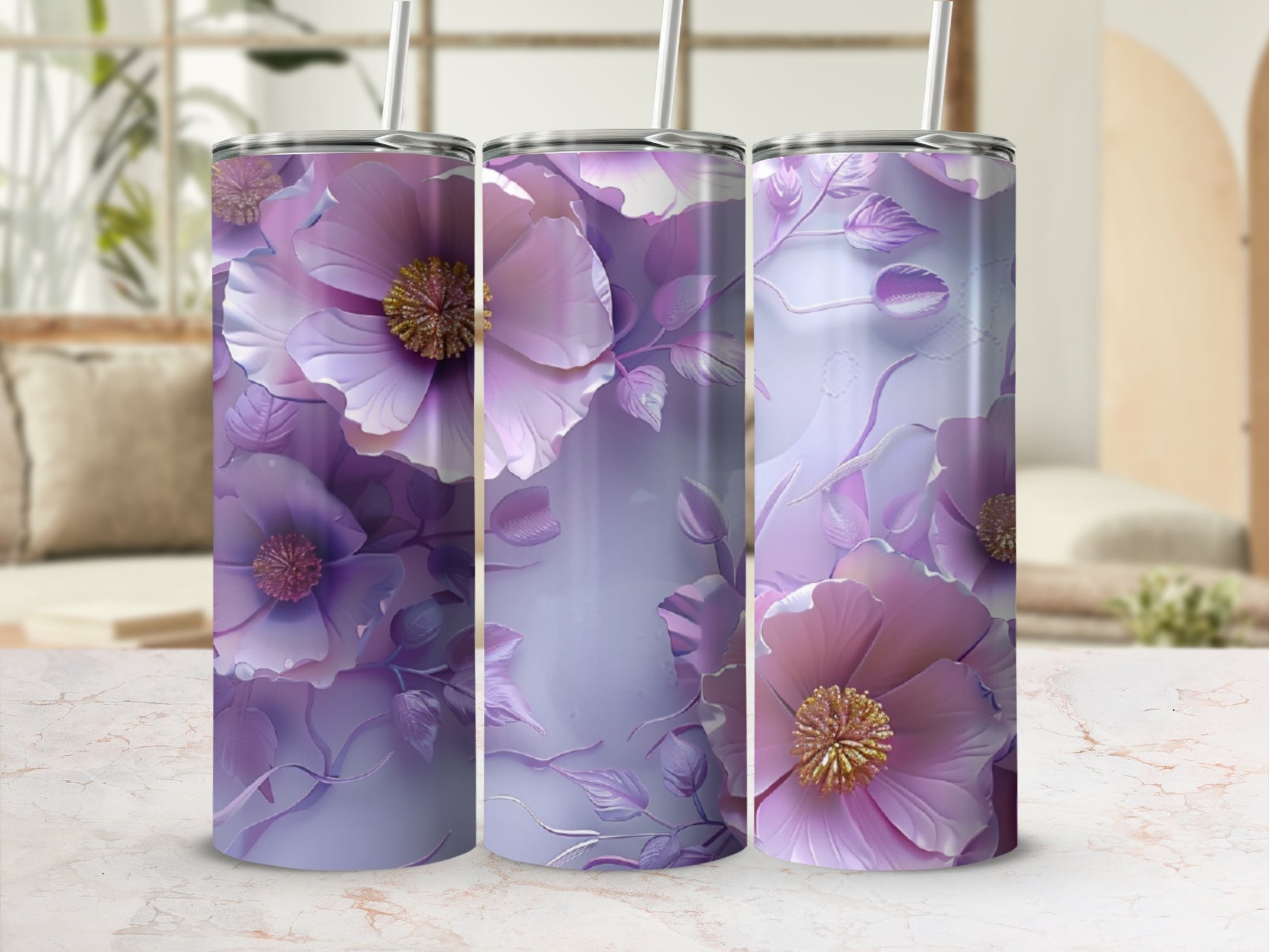 Three purple floral patterned tumblers with straws on a marble surface.