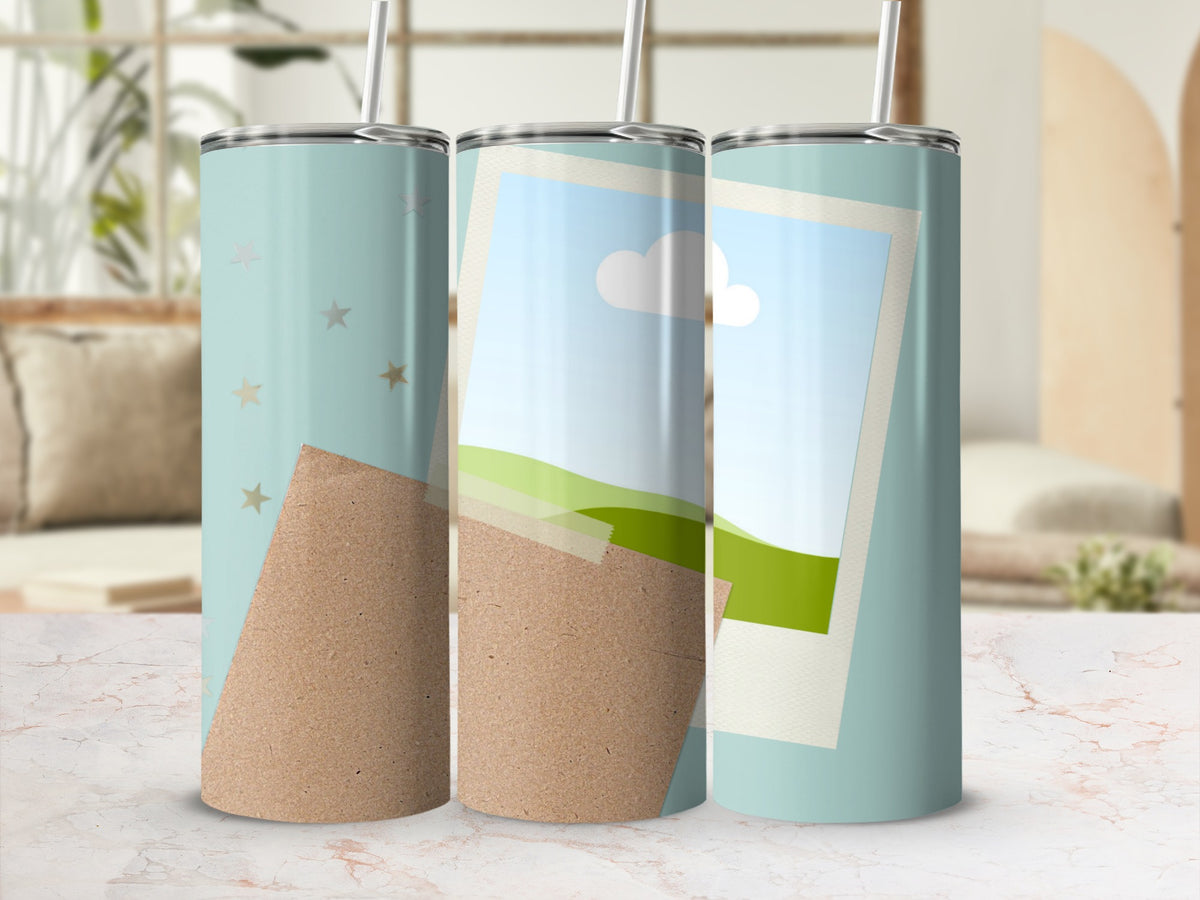 Three tumblers with sky, grass, and star designs on a marble surface.
