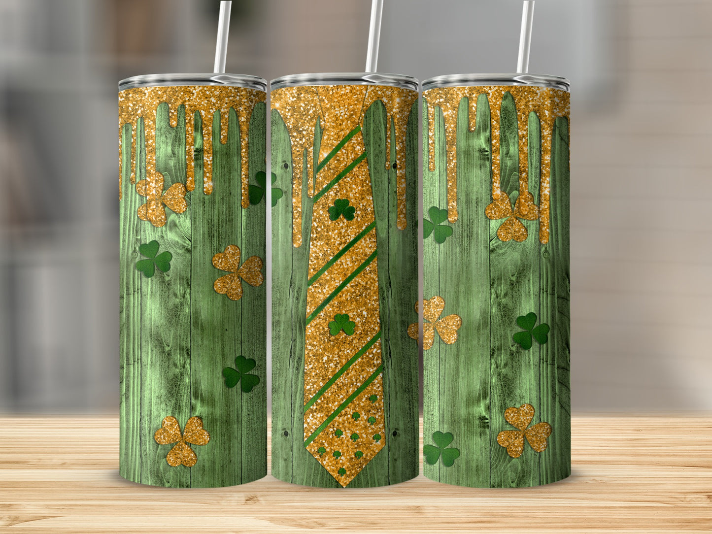 Three tumblers with green wood grain, gold glitter drips, and shamrock tie patterns.