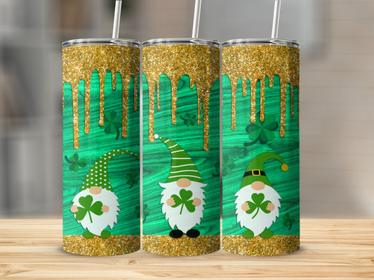 Three St. Patrick's Day gnomes with shamrocks on a green wood background.