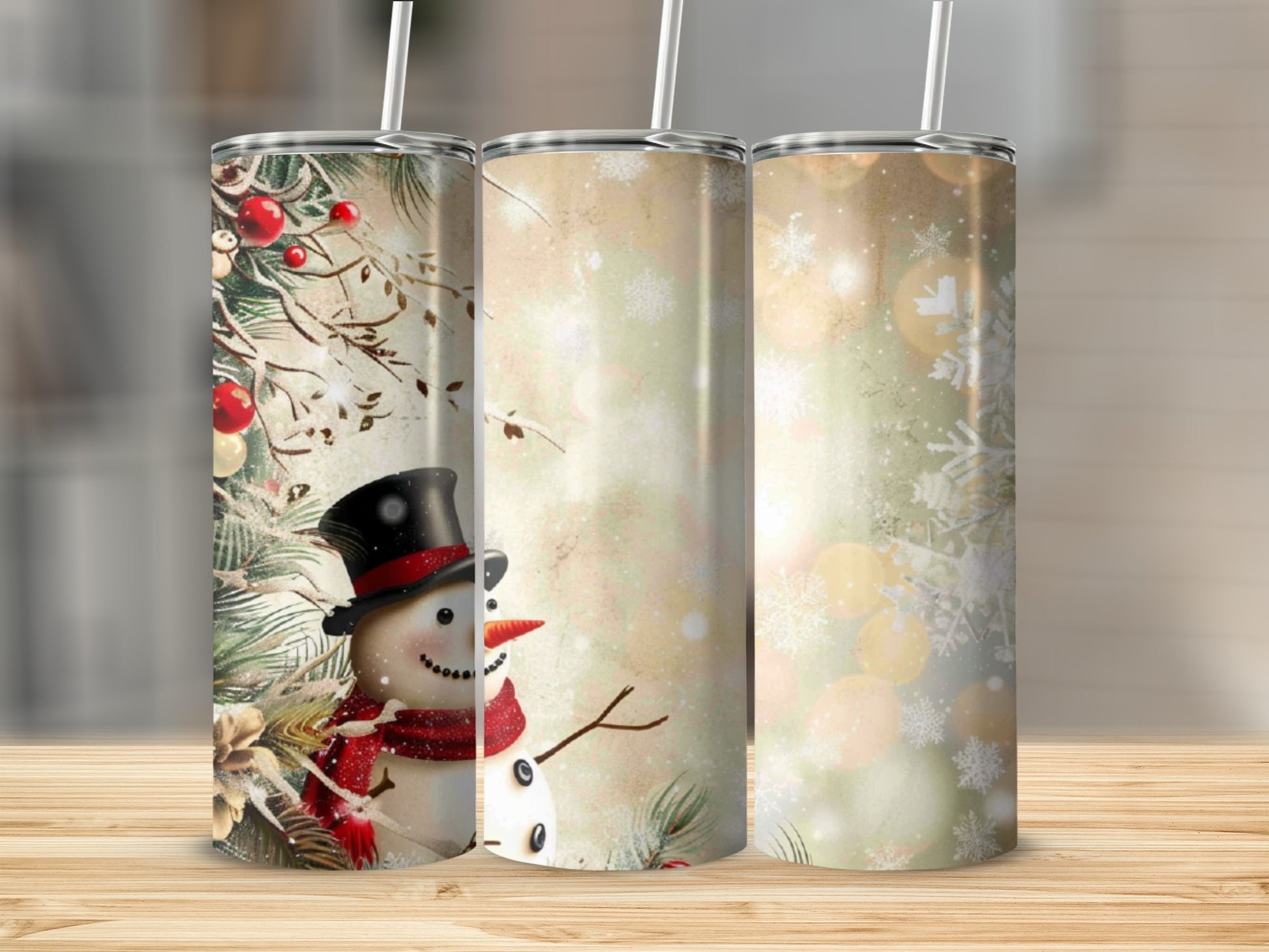 Three snowman tumblers with a festive winter scene.