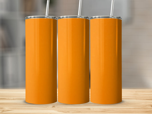 Three blank orange tumblers with straws on a wooden surface.