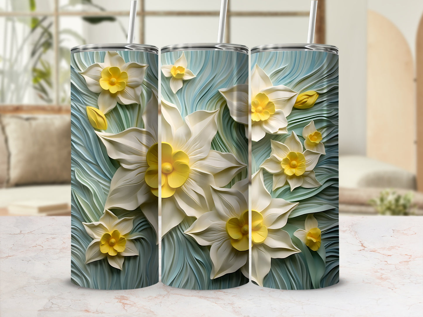 Three tumblers with white and yellow daffodils on a blue textured background.