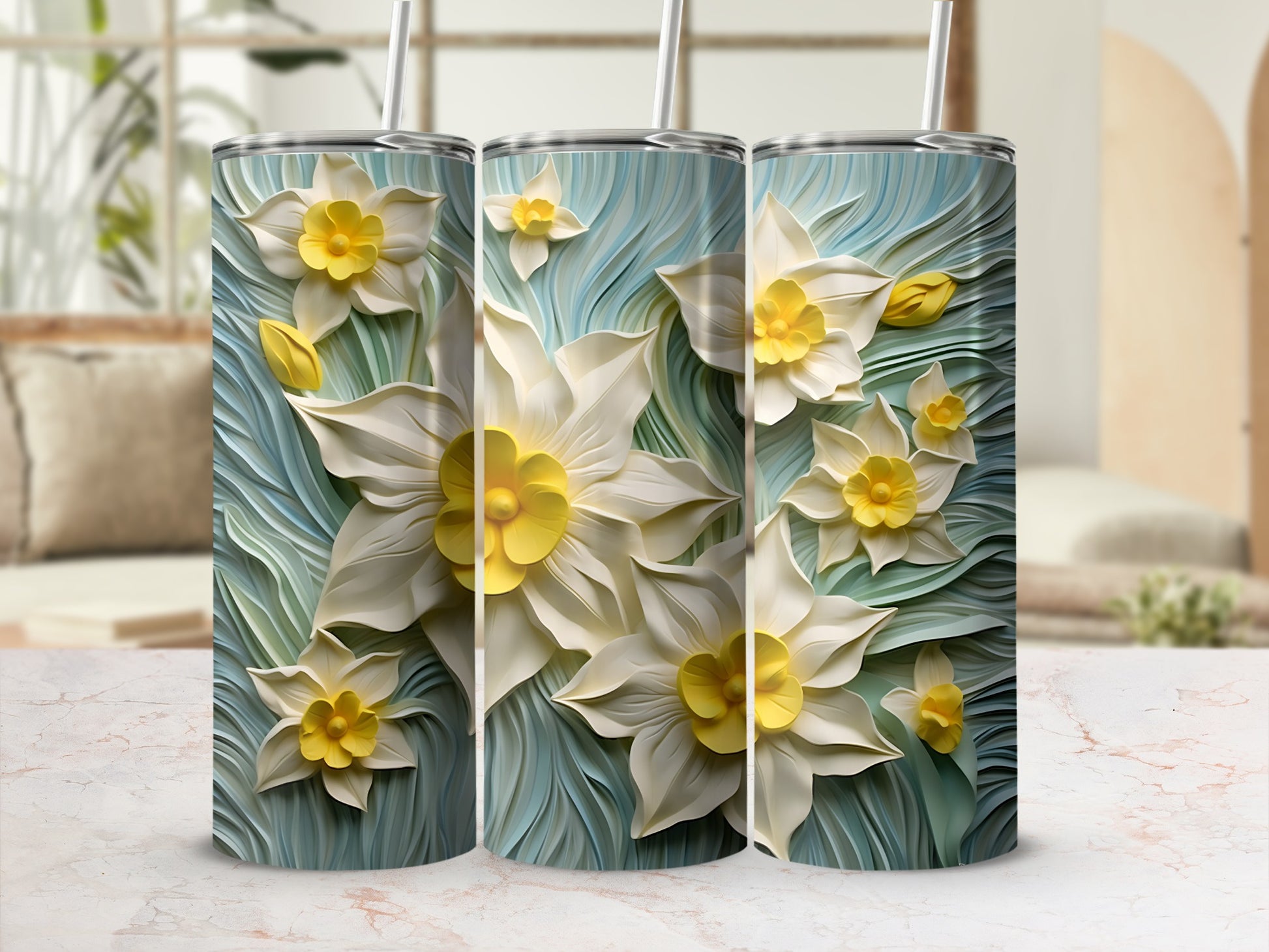 Three tumblers with white and yellow daffodils on a blue textured background.