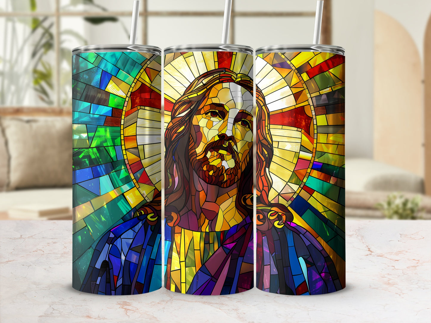 Jesus stained glass art on three tumblers with straws, on a countertop.