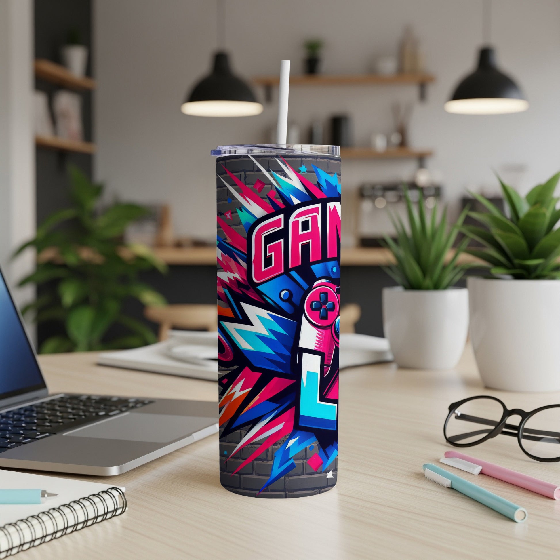 Graffiti-style "GAMER" text and controller on a gray brick tumbler with a straw.